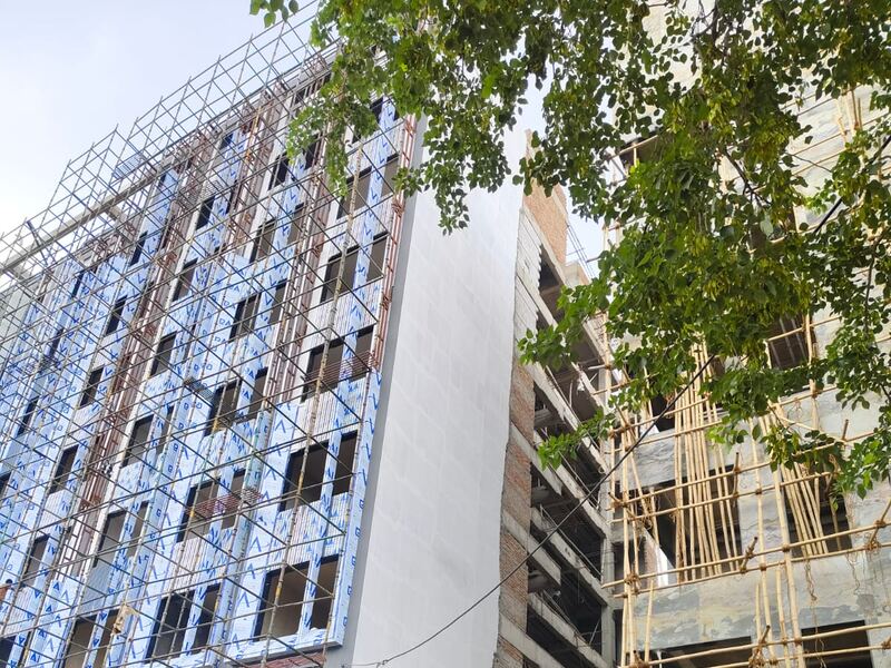 The building seen along its length with the scaffold up