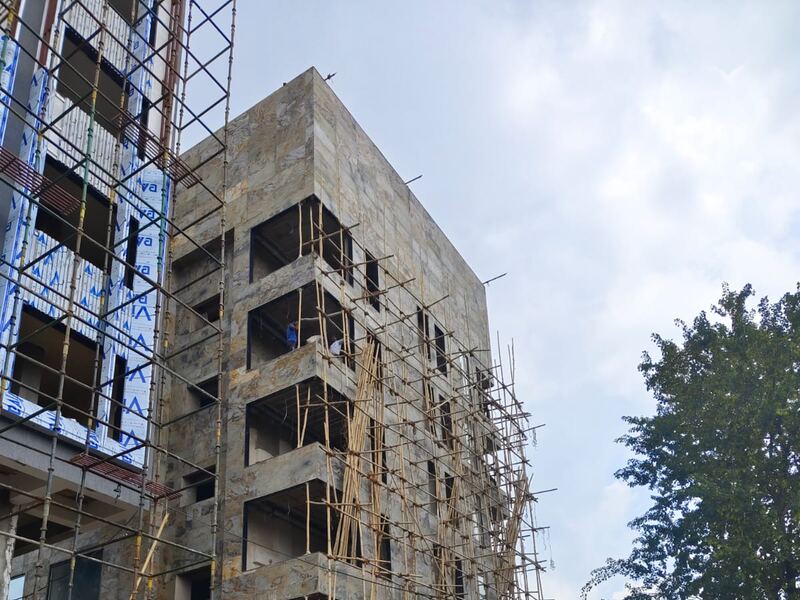 Reinforced concrete frame with scaffolding at an intermediate floor