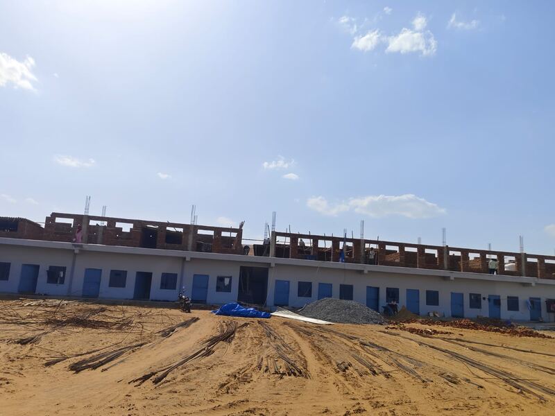 Row housing under construction across the length of the plot
