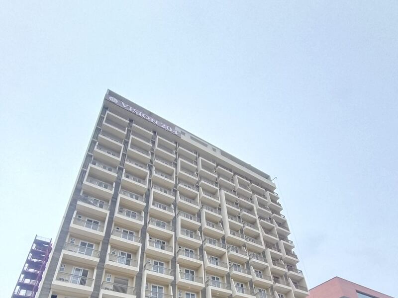 The tower from the front, with the podium entrance and boundary wall complete